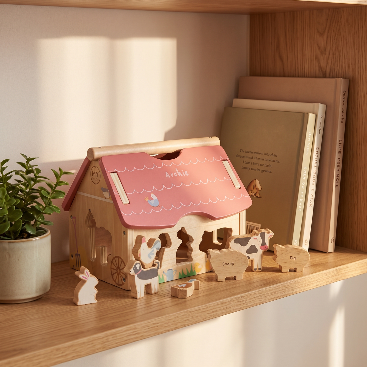 Farmhouse shape sorter with nine farm animal shapes laid out on a playmat