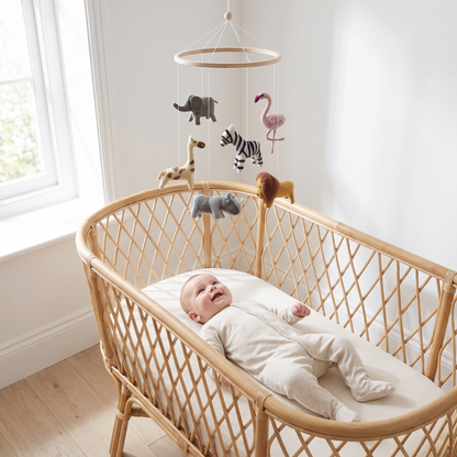 Wool safari animal mobile hanging in a natural-toned nursery
