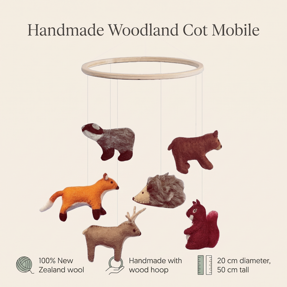 Woodland cot mobile styled above a nursery with natural decor