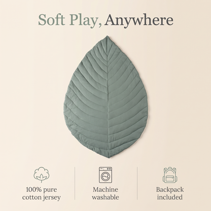 Sage green leaf cotton play mat styled in a neutral nursery