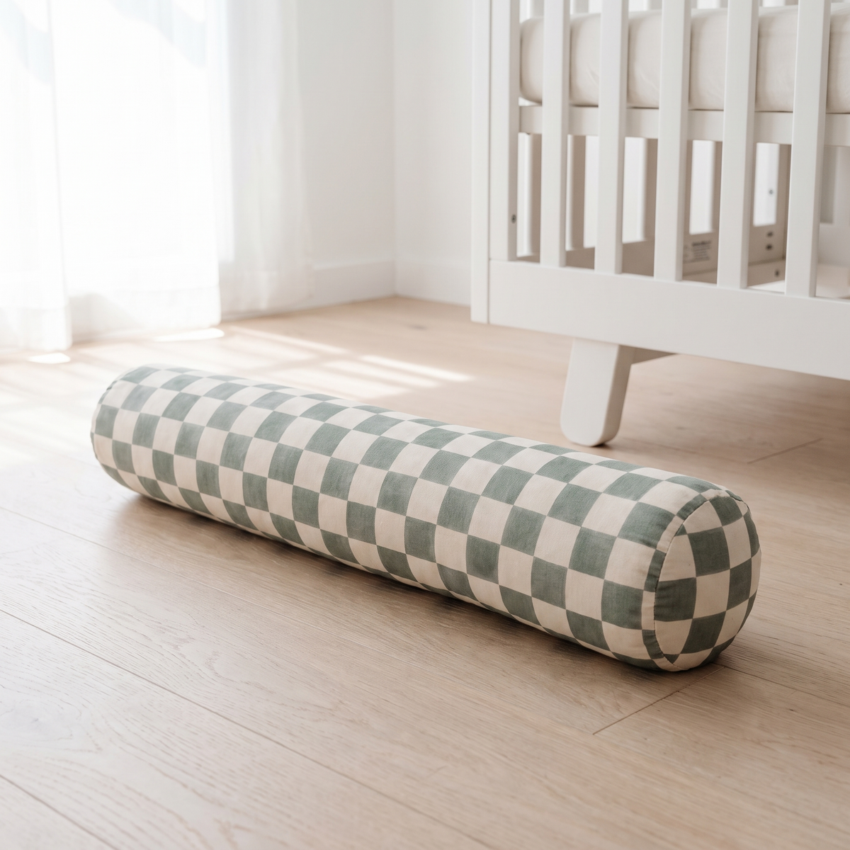 Checker matcha green kids support pillow on a playroom floor