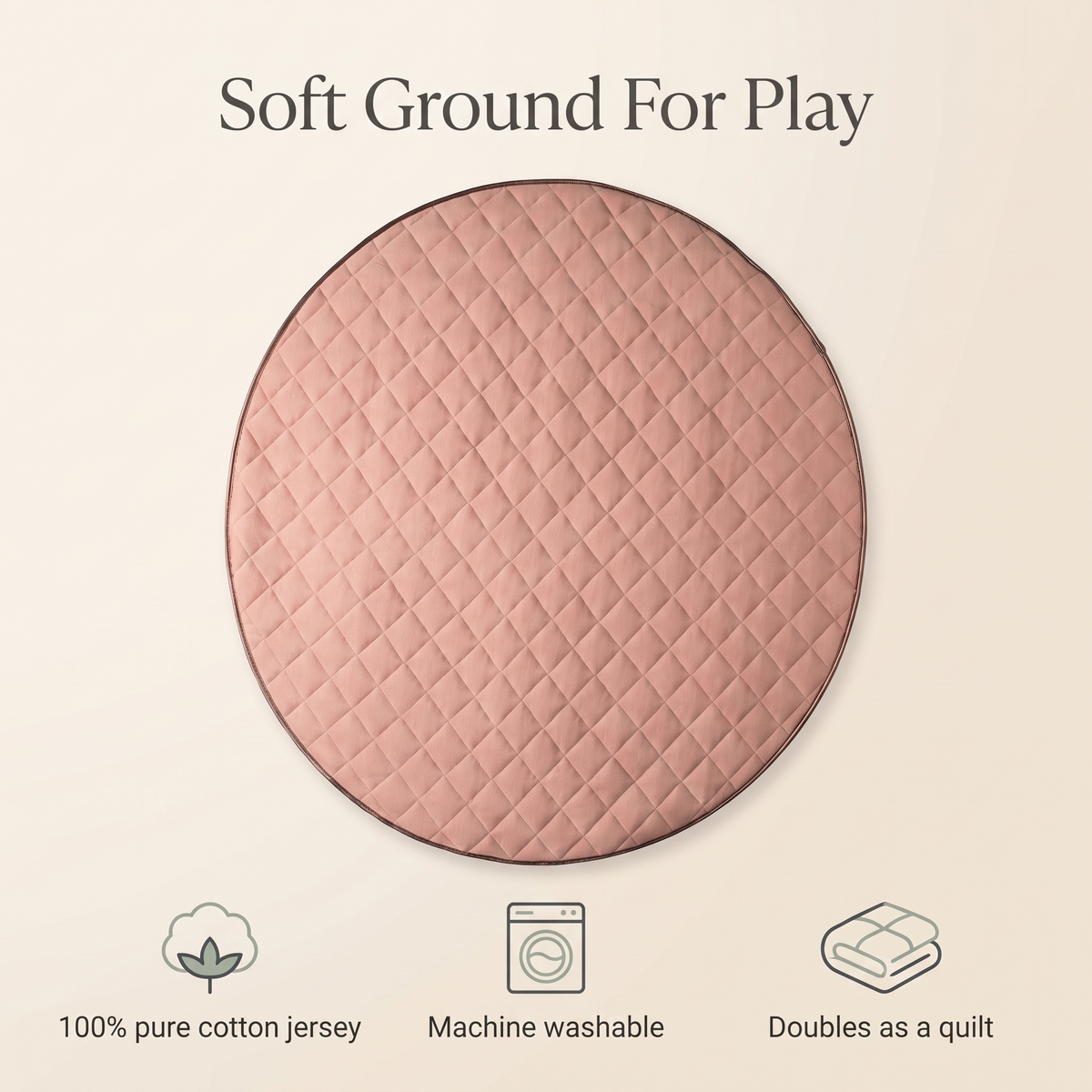 Round dusty pink quilted play mat styled in a soft neutral nursery