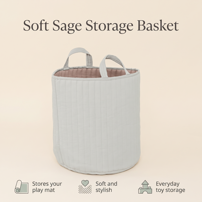 Sage green basket holding books and toys on a playroom floor