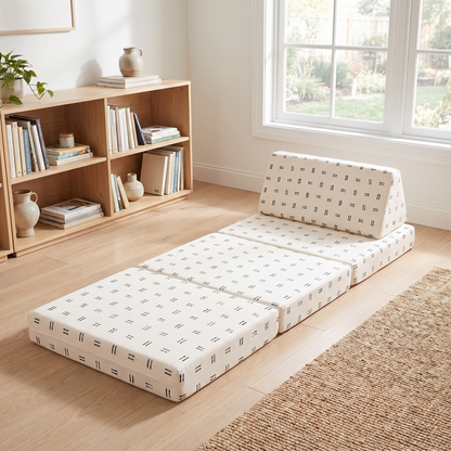 Mudcloth play couch opened out as a lounger in a kids reading nook