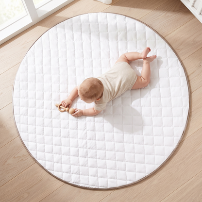 Close-up of the quilted white cotton jersey and leatherette border on the round play mat
