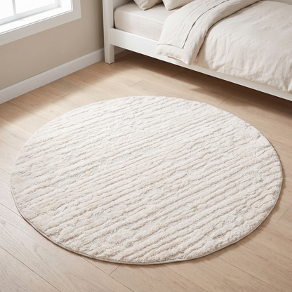 Little Teekie ivory cream round textured rug in a nursery