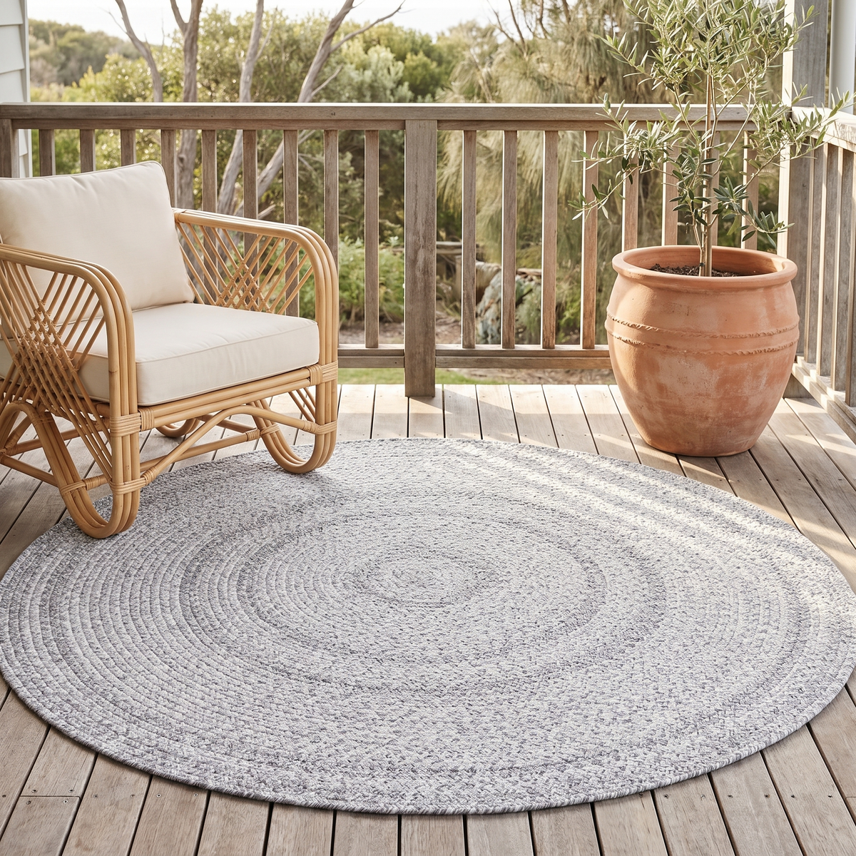 Close-up of handmade braided texture on grey round rug