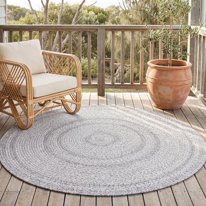 Close-up of handmade braided texture on grey round rug