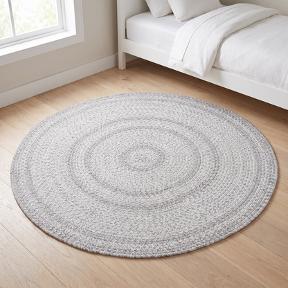 Little Teekie grey round braided flatweave rug in a kids playroom