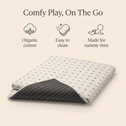 Large mudcloth play mat styled in a modern neutral nursery