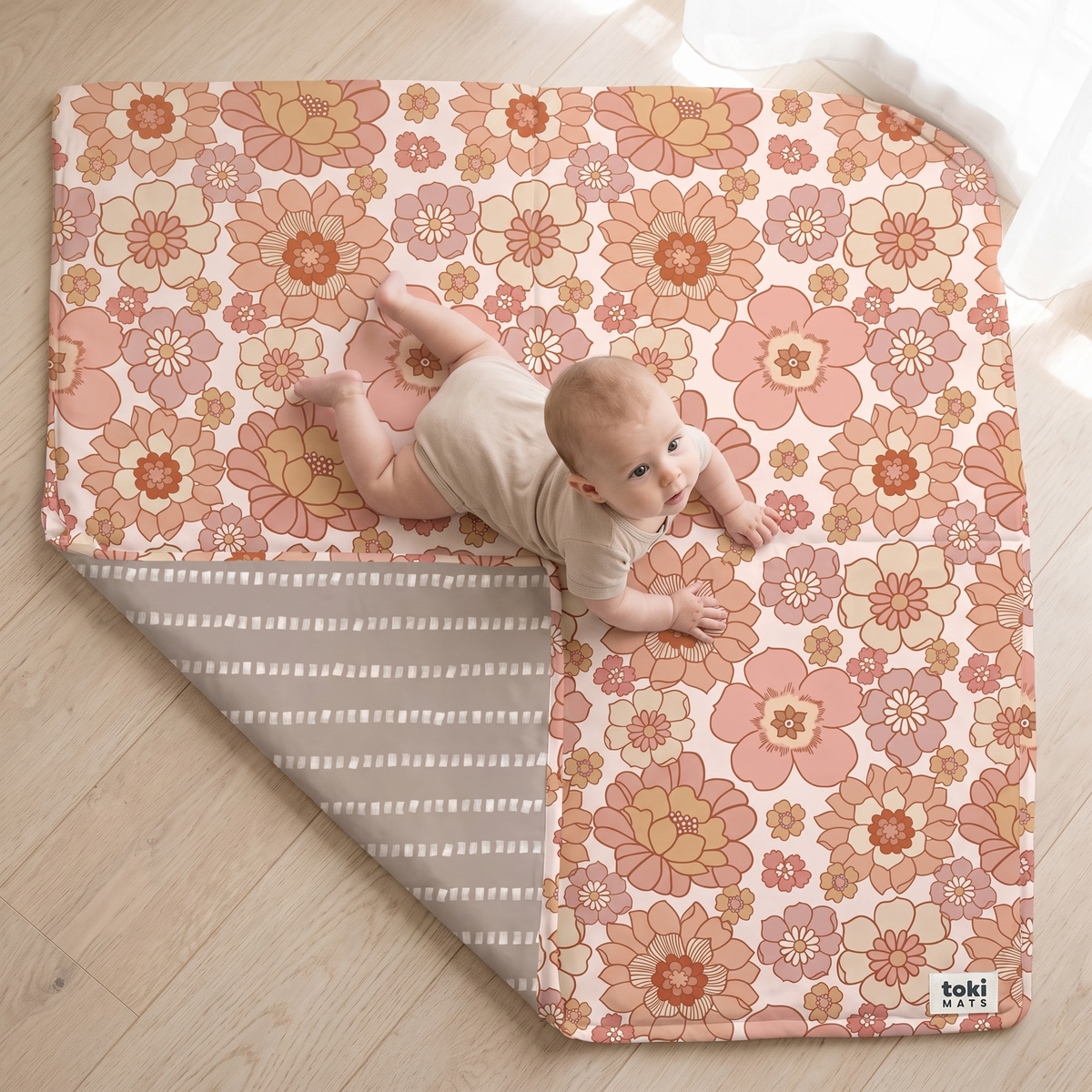 Close-up of the blooms floral organic cotton fabric and padding on the play mat