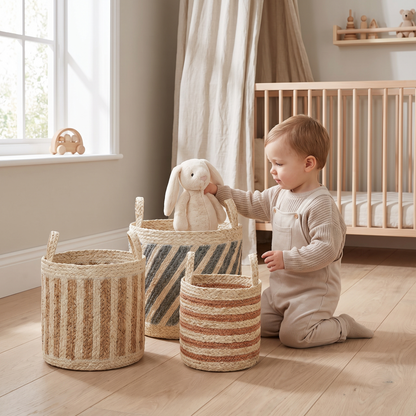 Three natural striped woven baskets holding toys and blankets in a playroom