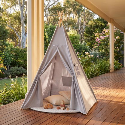 Grey teepee tent styled as a kids reading nook with cushions