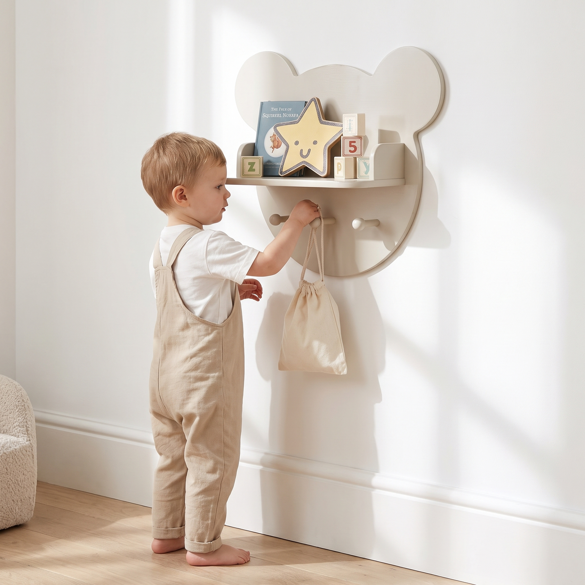 Bear-shaped kids wall shelf in pebble styled above a cot