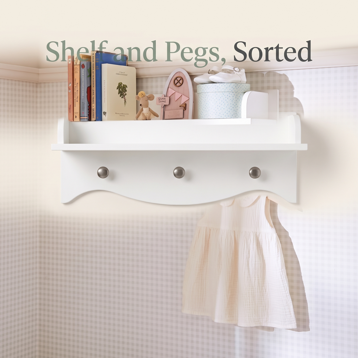 White nursery wall shelf with hooks in a bright kids bedroom