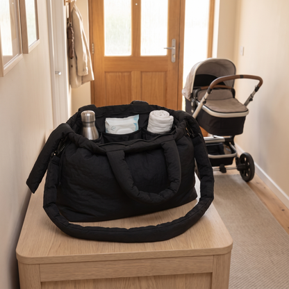 Little Teekie Recycled Nylon Pram Caddy | Lightweight Baby Bag – Black – styled in a park setting