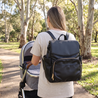 Little Teekie Convertible Nappy Backpack | Pebbled Vegan Leather, 5-Way Carry, Insulated Pockets – Black – in use, shows scale