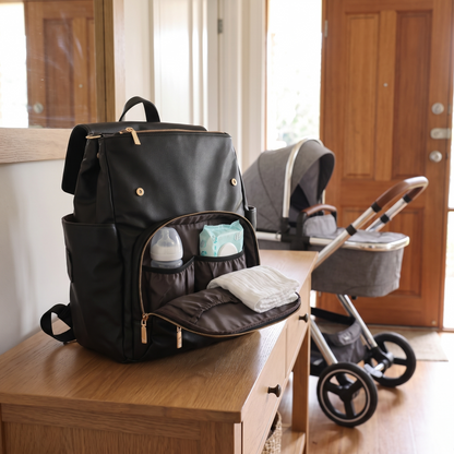 Little Teekie Convertible Nappy Backpack | Pebbled Vegan Leather, 5-Way Carry, Insulated Pockets – Black – styled in a park setting