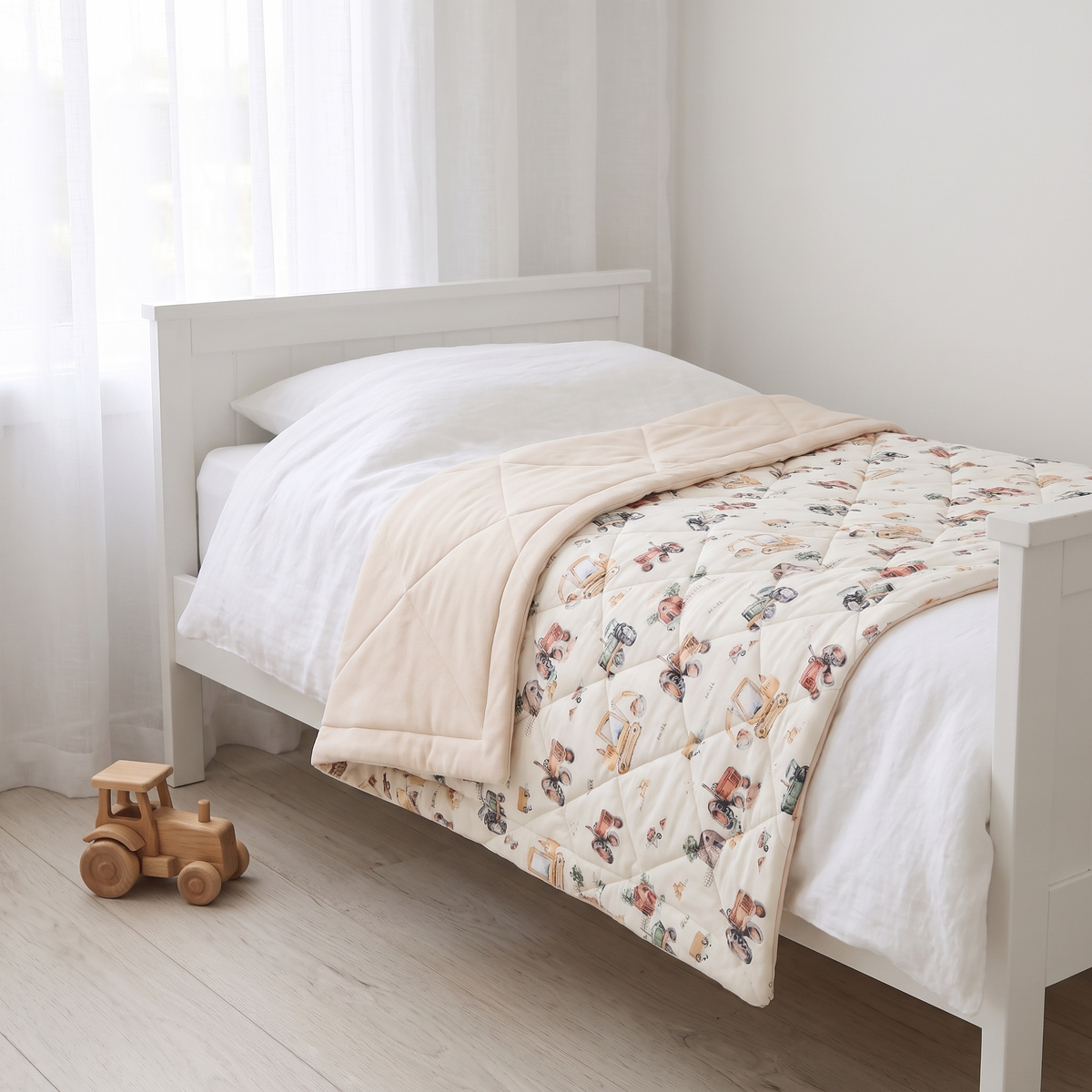 Little Teekie Reversible Quilted Organic Jersey Cot Comforter | 100x120cm – Vehicles Print – styled in a toddler bedroom