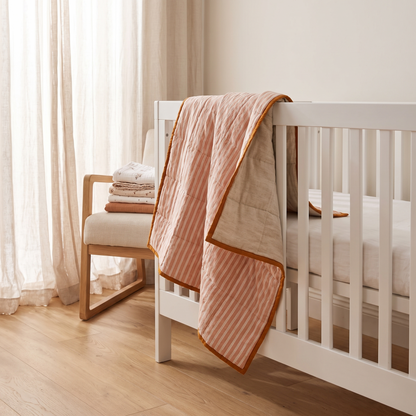 Little Teekie Linen Double-Sided Cot Quilt | Pre-Washed 100x120cm – Terracotta / Oat – styled in a nursery