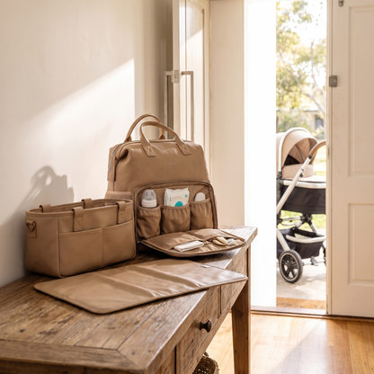 Little Teekie Ultimate Baby Bag Bundle | Nappy Backpack, Pram Caddy & 3-Piece Changing Set – Tan – styled in a park setting