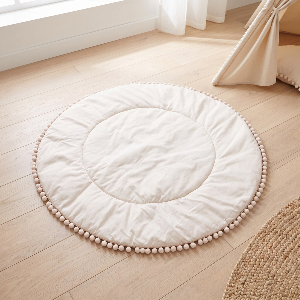 Little Teekie Quilted Cotton Round Play Mat | Pom-Pom Trim 110cm – Oat – lifestyle hero