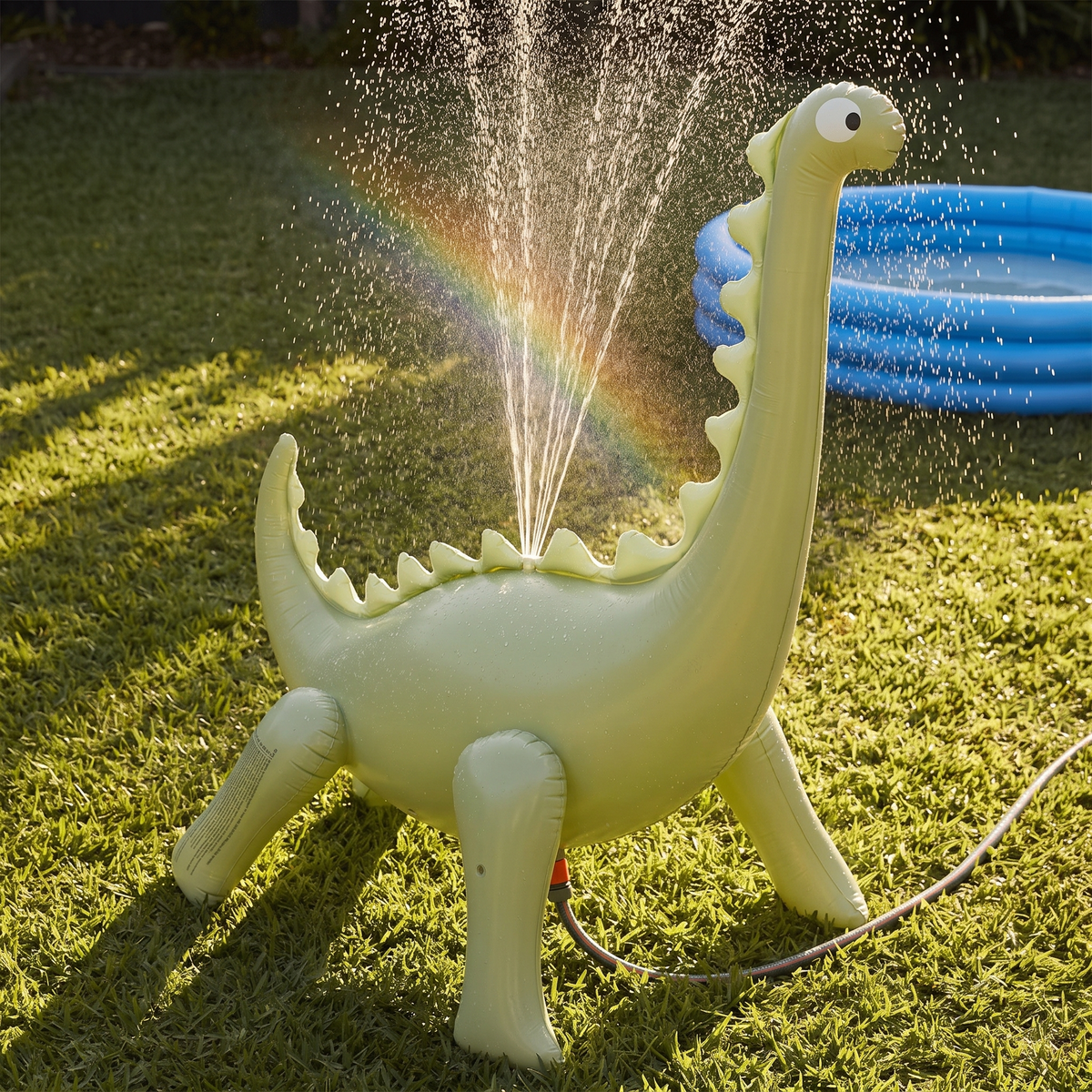 Little Teekie Giant Inflatable Dinosaur Sprinkler | Phthalate-Free PVC with Hose Adaptor – Dino Green – styled in a backyard