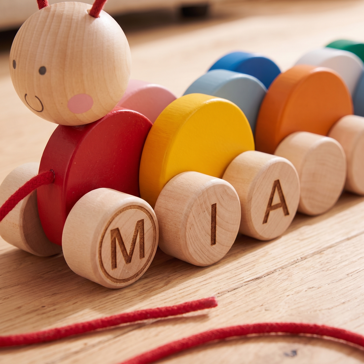Little Teekie Personalised Wooden Pull Along Caterpillar | Engraved Name, Red Rope – Rainbow – personalisation detail