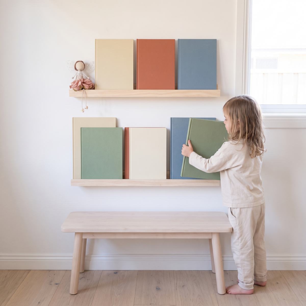 Little Teekie Minimalist Book Display Ledge | Wall-Mounted 60cm, 4cm Depth – Natural Wood – in use, shows scale