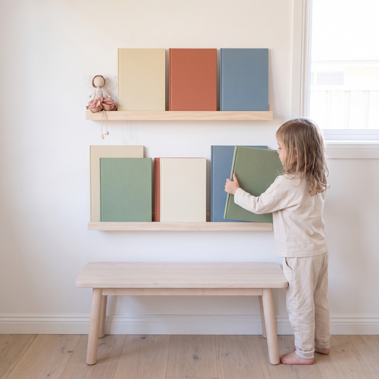 Little Teekie Minimalist Book Display Ledge | Wall-Mounted 60cm, 4cm Depth – Natural Wood – in use, shows scale