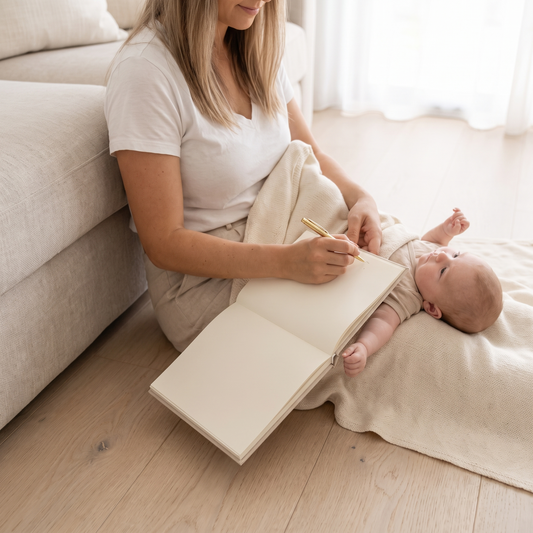 Little Teekie Baby Memory Book | Cloth Hardcover, Gold Foil, 98 Pages – Neutral Cloth – in use, shows scale